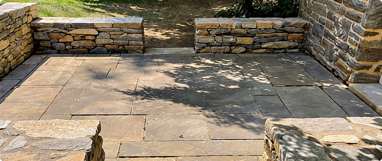 Natural stone walkway and outdoor steps with stone masonry walls surrounding a residential entrance.